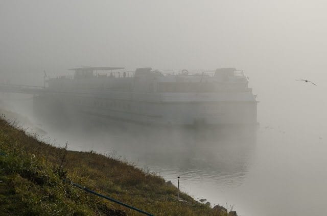 The stern of CroisiEurope's Monet emerges from the fog in Breisach, Germany. Photo © 2013 Aaron Saunders