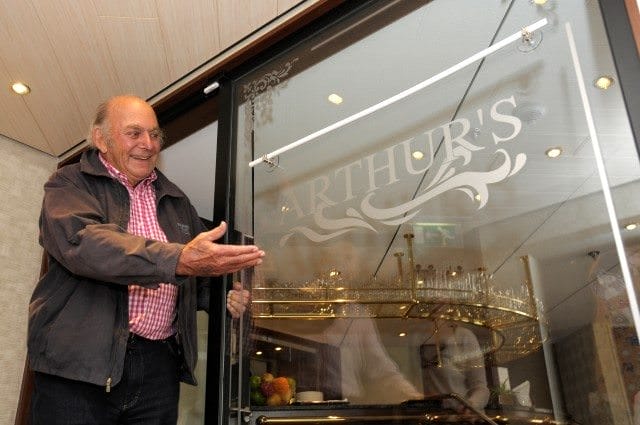 Tauck chairman Arthur Tauck, Jr., showcases the new casual dining venue aboard ms Inspire that bears his name. Photo courtesy of Tauck