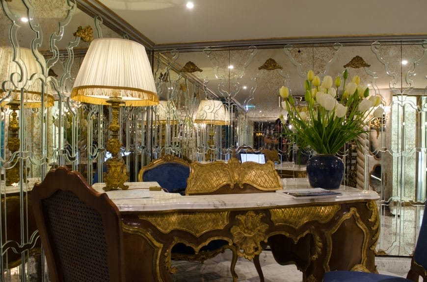 Check out the Cruise Director's desk at the Reception Lobby. The gold partition rising above the desk hides the laptop computer behind it. Clever! Photo © 2015 Aaron Saunders