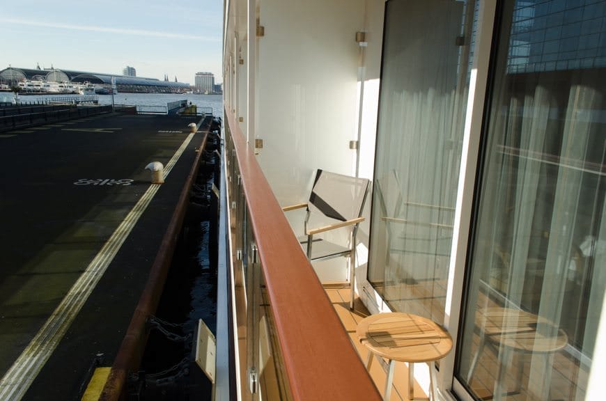 Category A Veranda Staterooms feature full step-out balconies with two chairs and a small table. Photo © 2015 Aaron Saunders