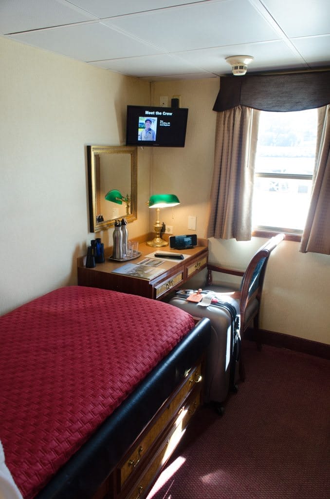 Staterooms are small, but well laid-out. The full-sized writing desk is a nice touch, as is the combination flat panel television and DVD player. Photo © 2015 Aaron Saunders