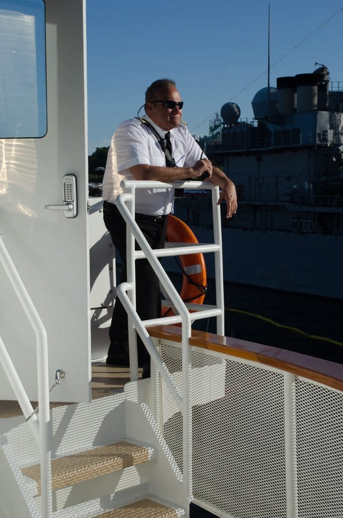Captain Scott watches from the portside bridge wing...Photo © 2015 Aaron Saunders
