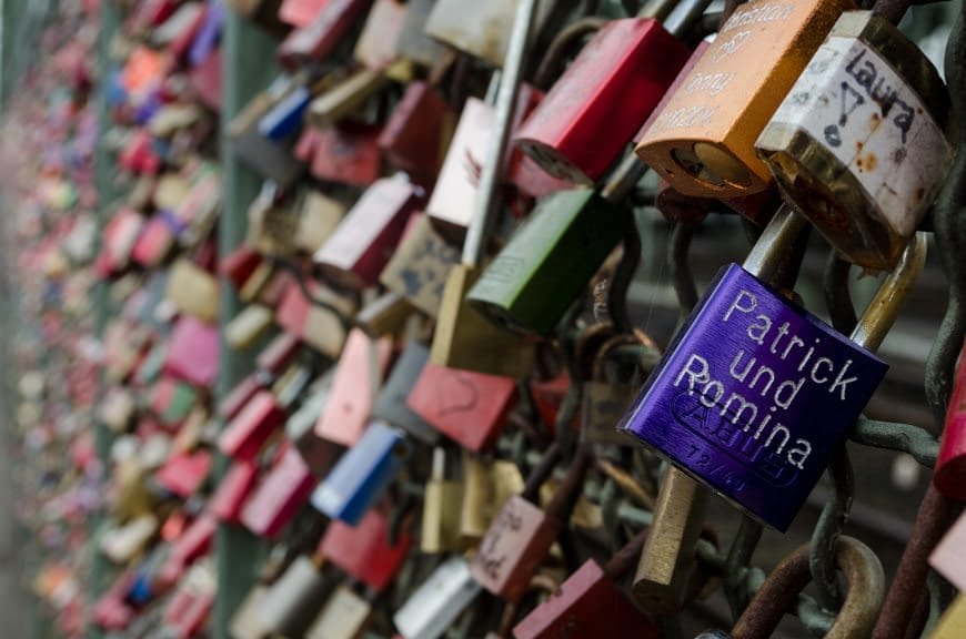 Thousands upon thousands of "Love Locks" are chained to the barriers that separate the pedestrian walkway from the main rail tracks of the bridge. Photo © 2015 Aaron Saunders