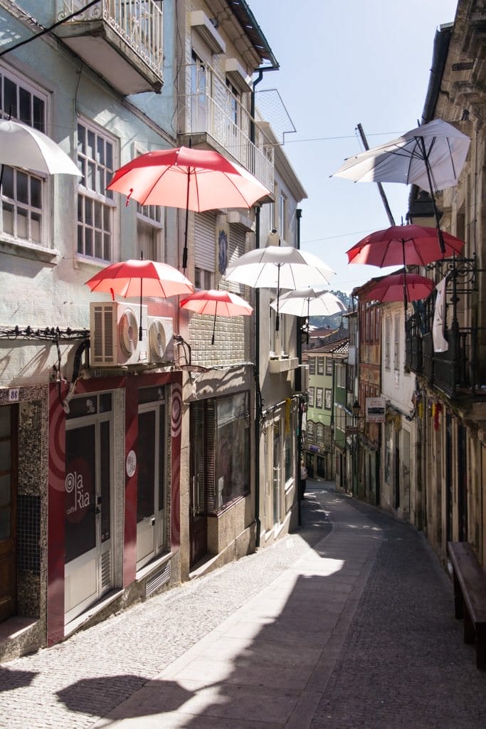 Umbrellas line a street in Lamego, Portugal. Photo © 2015 Aaron Saunders