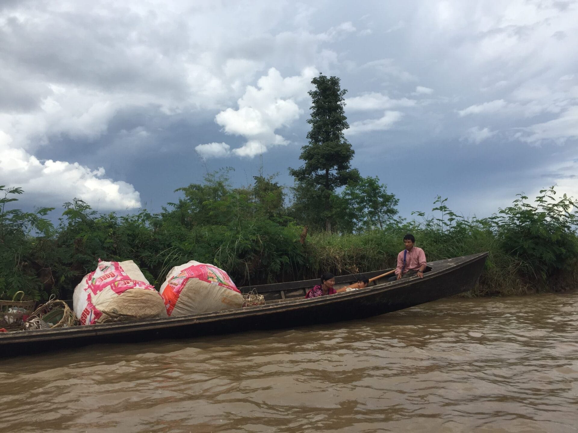 People who live on, around, and in the lake use long wooden boats to accomplish every errand imaginable. © 2015 Gail Jessen