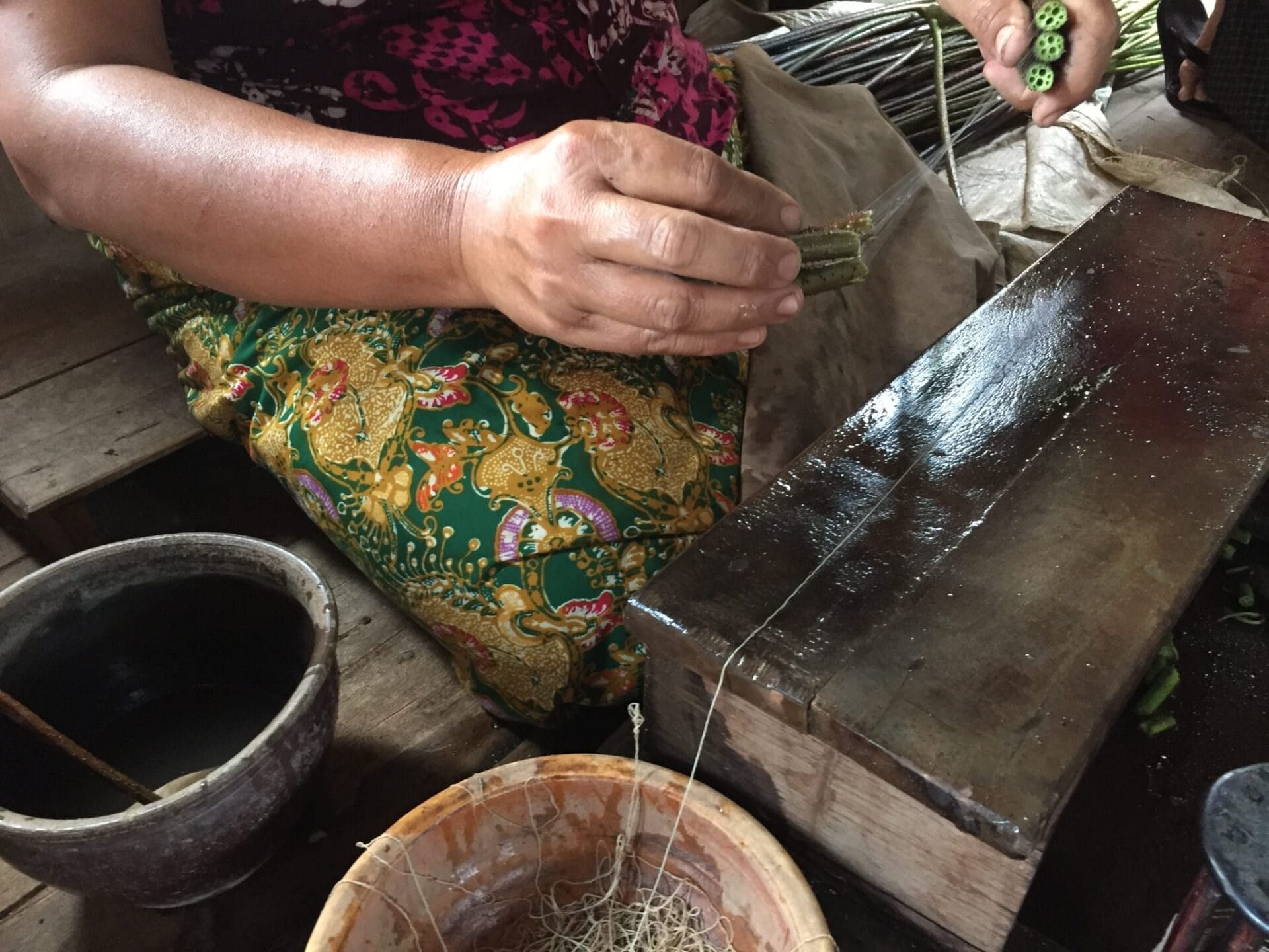 Fibers from the center of the lotus stem create strong threads that are woven into blankets and scarves. It's a painstaking manual process. © 2015 Gail Jessen