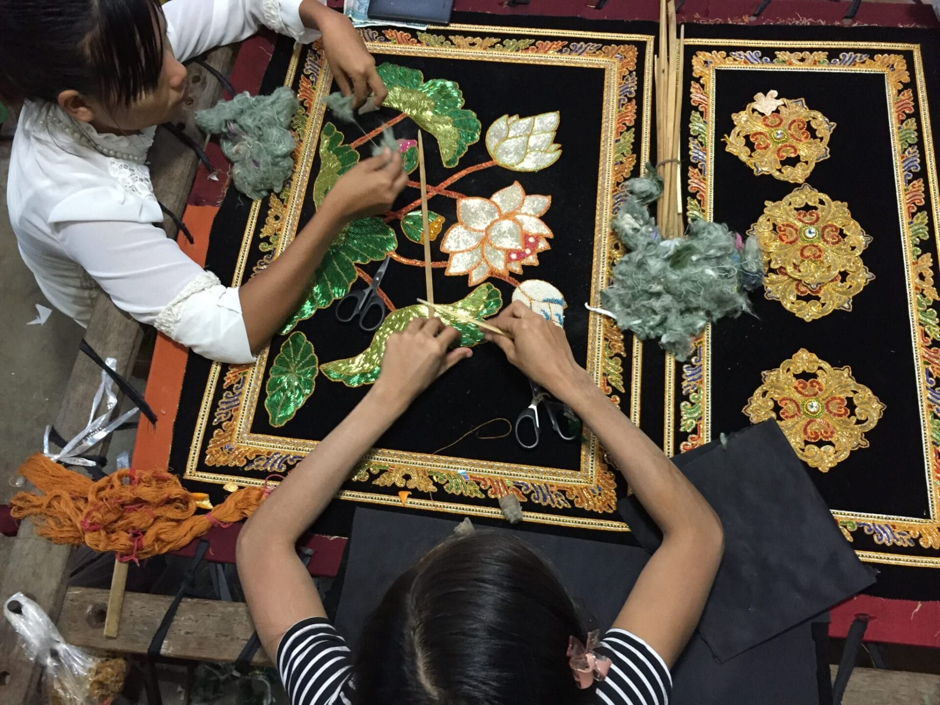 A Burmese kalaga is a decorative, embroidered cloth. They are unique in their design with sequins, 24 carat gold thread, and raw cotton shoved under the patterns to create 3D images. © 2015 Gail Jessen