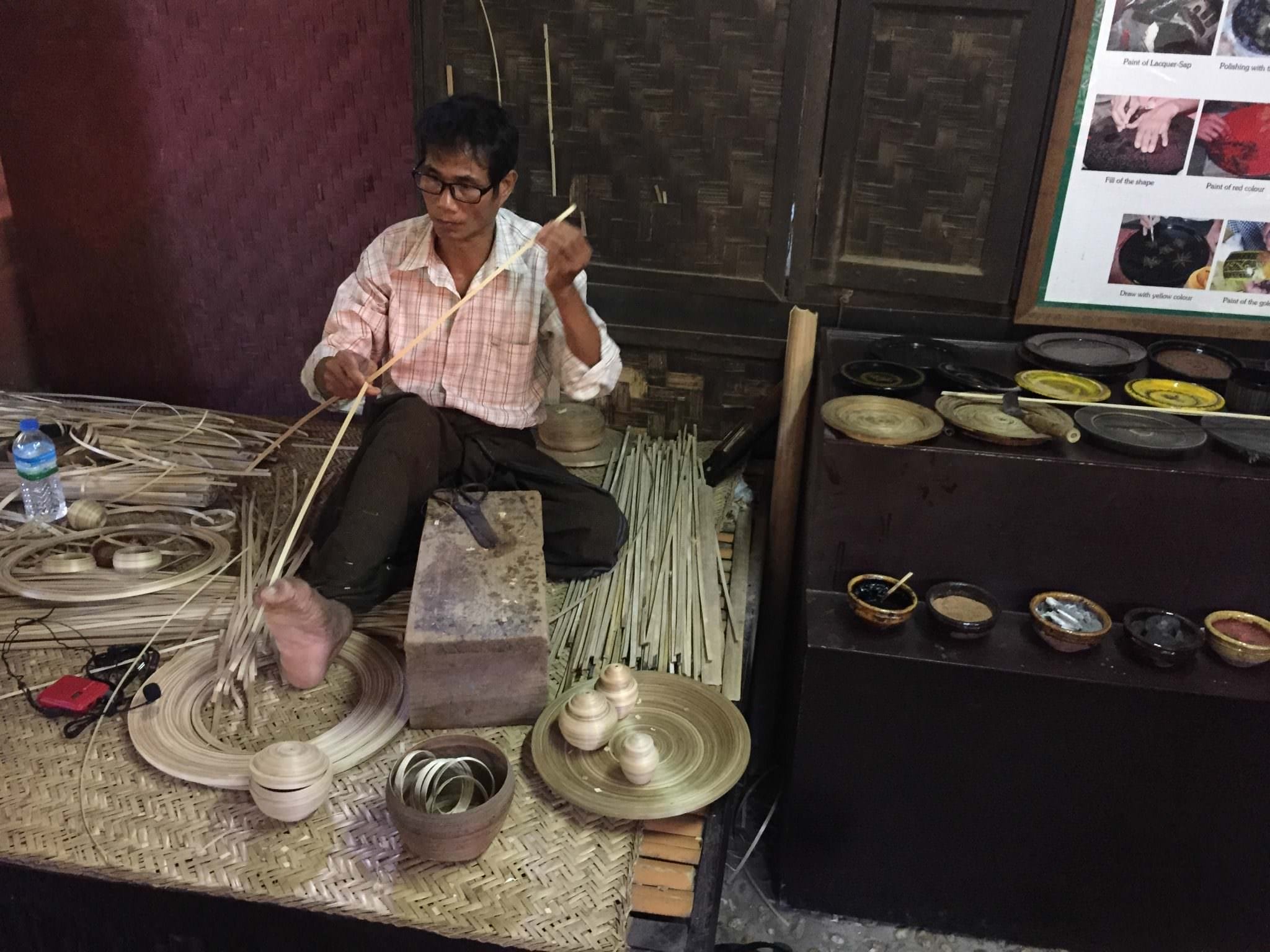 The artisan separates bamboo with his toes, pulling thinner and thinner strips apart i preparation for a bracelet. © 2015 Gail Jessen