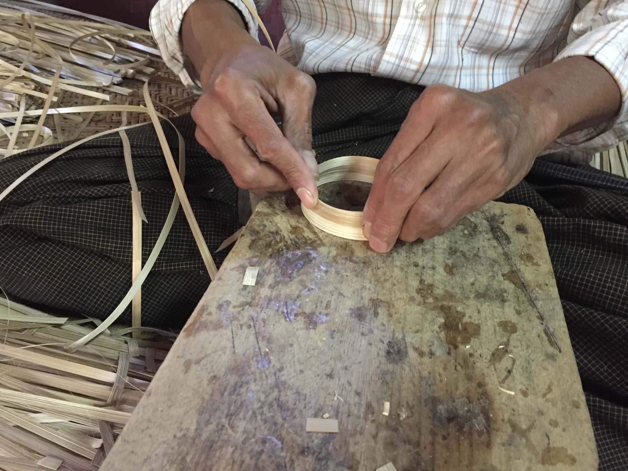 He cuts notches into the ends of bamboo strands, interlocking them and forming a bracelet with no nails or glue. © 2015 Gail Jessen