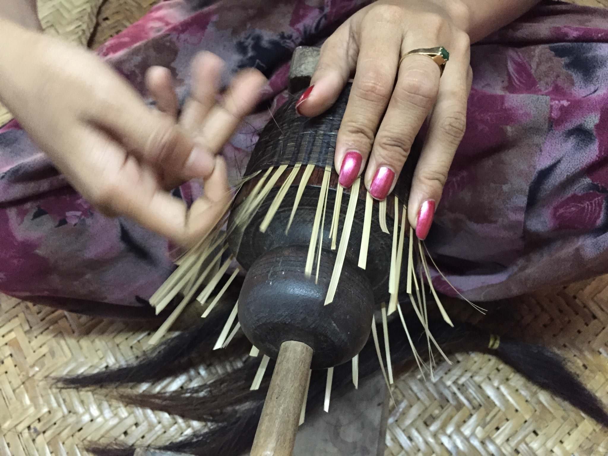 Some pieces are woven together with horse hair. One single hair at a time, over under over under over under small bamboo strips. The final product of her work is a cup the size of a scotch tumbler. © 2015 Gail Jessen