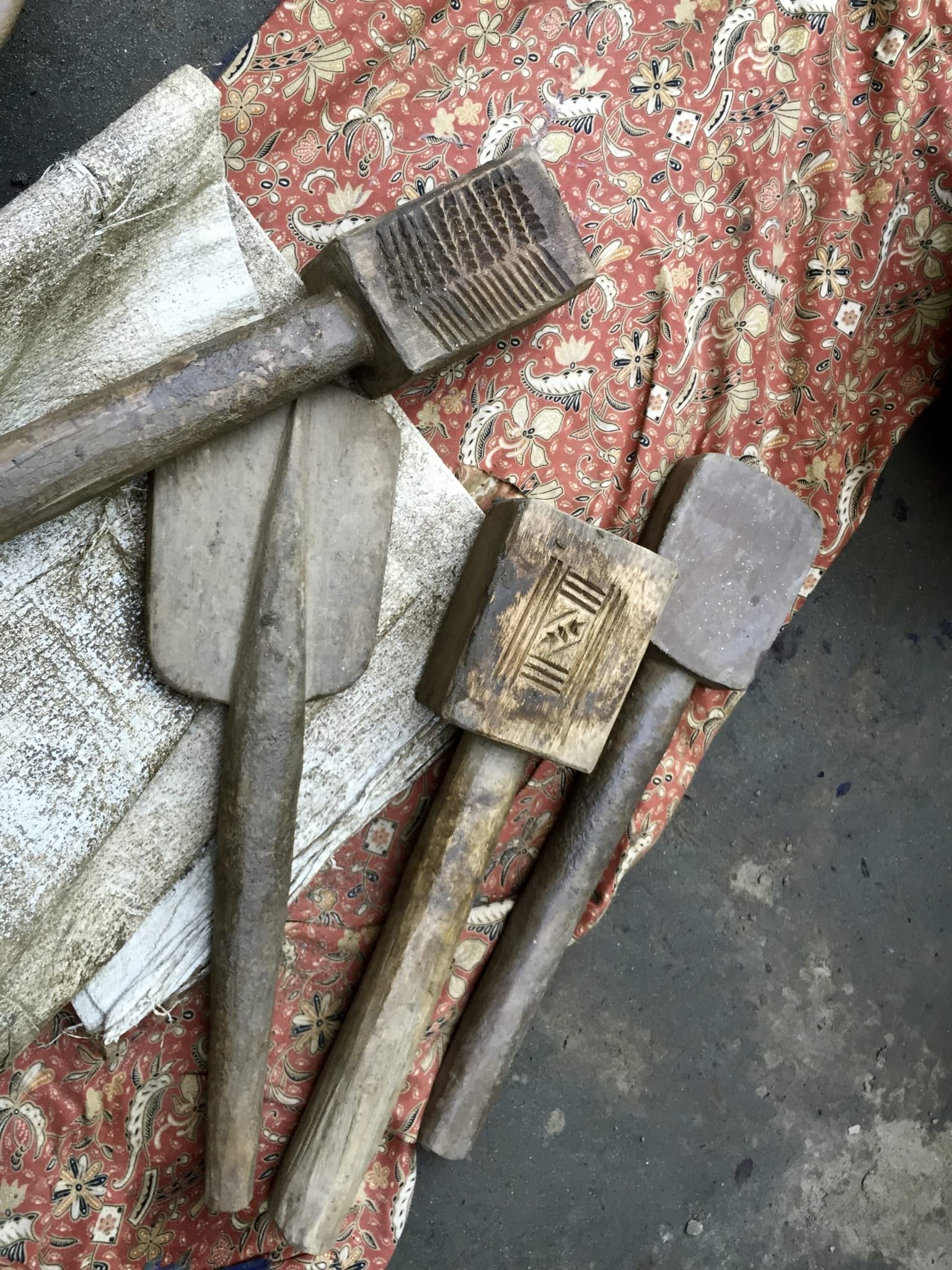 Wooden paddles carved with family insignia make unique designs on the outside of the water pots. © 2015 Gail Jessen