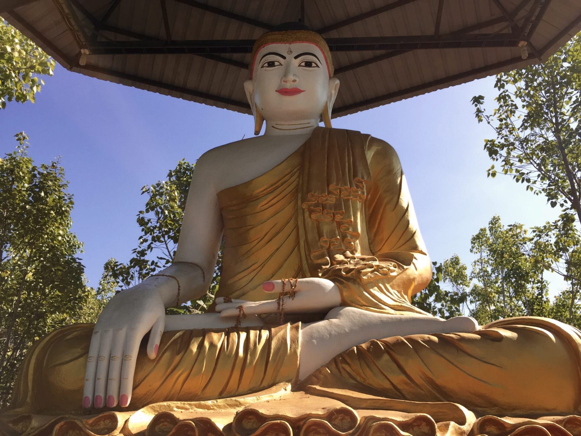 Viking Mandalay: 500,000 Buddhas In Monywa, Myanmar 23 One central statue watches over the park. The mudra of this Buddha's hands symbolizes meditation (left) and not wavering from that practice by staying grounded under the bodhi tree until he achieves enlightenment (right). © 2015 Gail Jessen