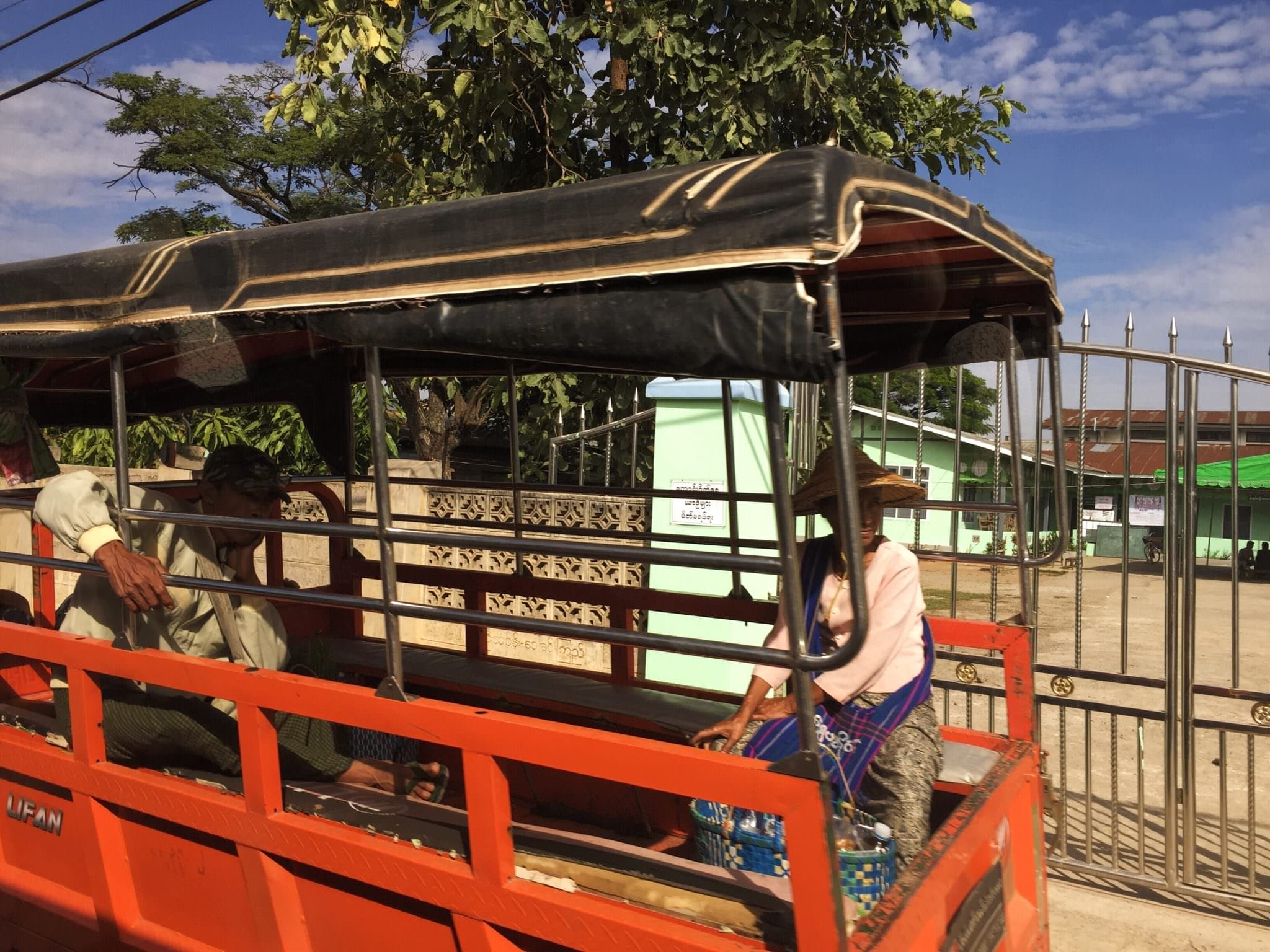 Public transportation in Myanmar is typically handled in the bed of pick up trucks. More often than not, a motorcycle has been welded to the front of the truck bed. Sometimes there is a roof, sometime there are seats, sometimes there are neither. © 2015 Gail Jessen