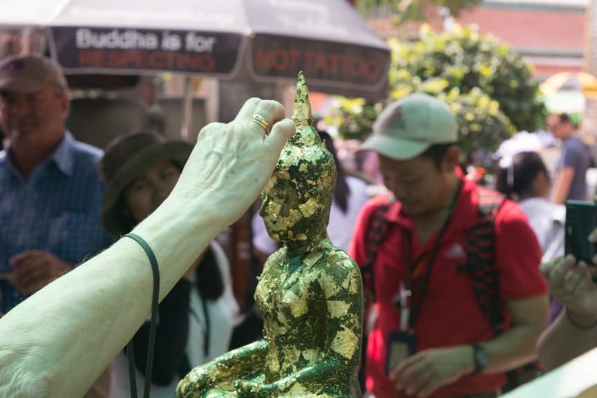 Guests were invited to add gold leaf to Buddha; doing so ensures good luck. Photo © 2015 Aaron Saunders