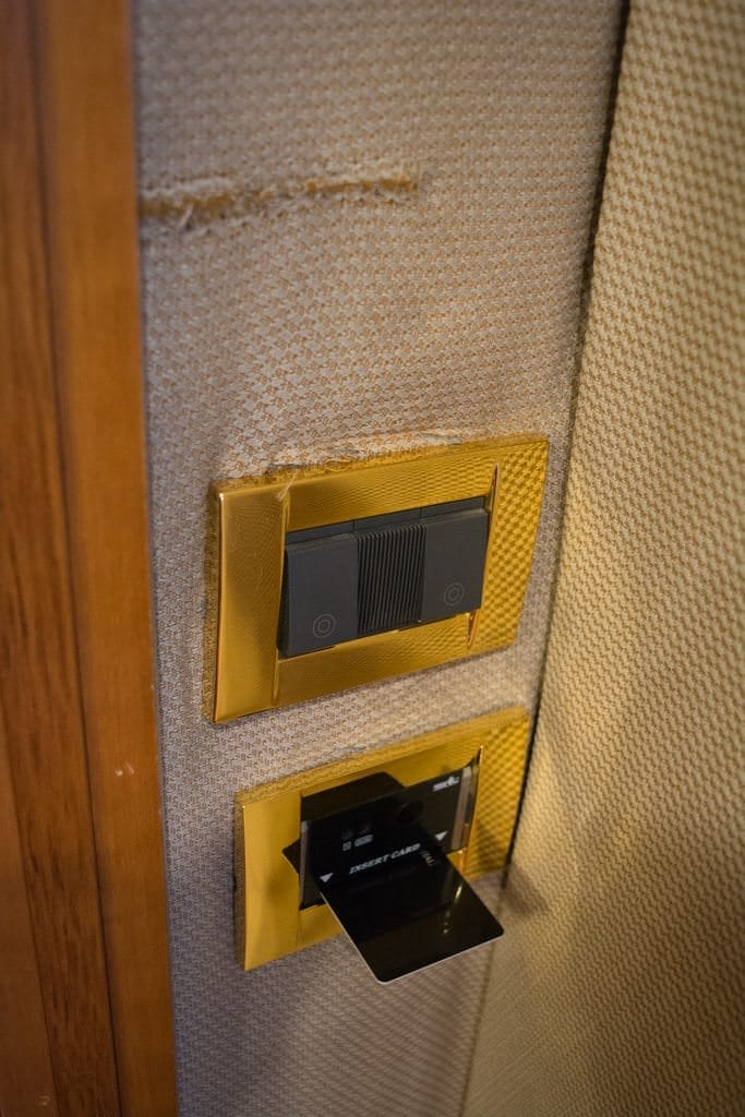 Damaged wall and kneecap-height keycard insertion slot that turns on the AC. Photo © 2016 Aaron Saunders